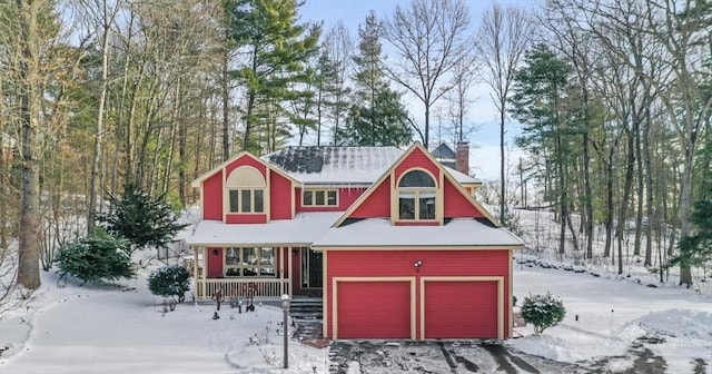 snow covered structure featuring covered porch