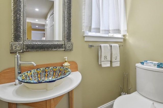 bathroom featuring toilet and sink