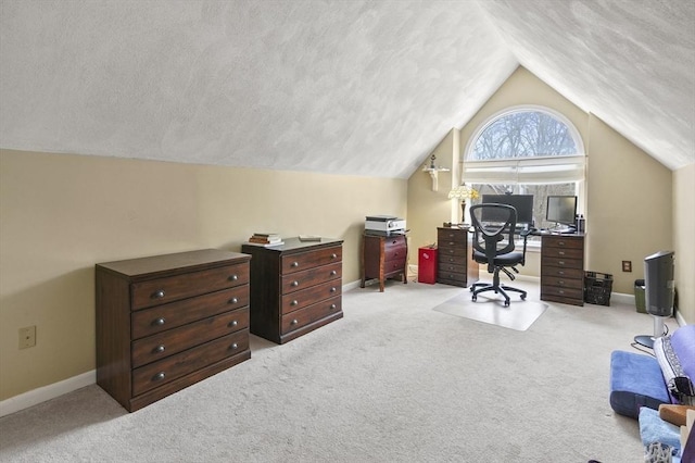 carpeted office space featuring vaulted ceiling and a textured ceiling