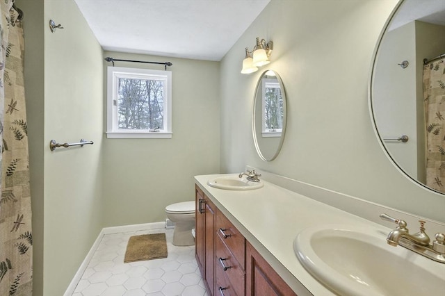 bathroom with vanity, tile patterned floors, and toilet