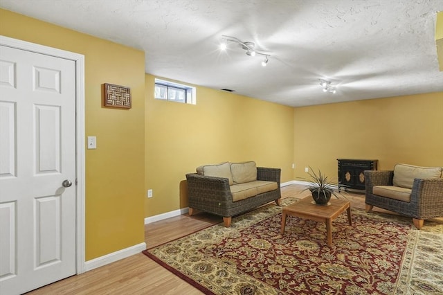 living room with wood-type flooring and a textured ceiling