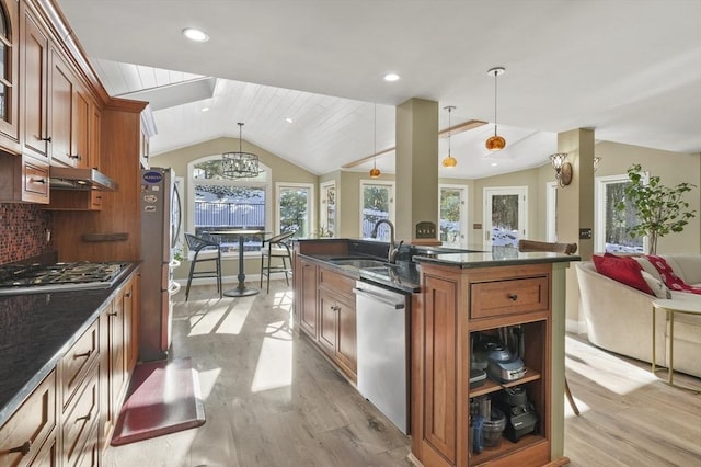 kitchen with decorative light fixtures, tasteful backsplash, lofted ceiling, stainless steel appliances, and light wood-type flooring