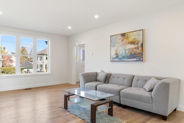 living area featuring recessed lighting, baseboards, visible vents, and light wood-style flooring