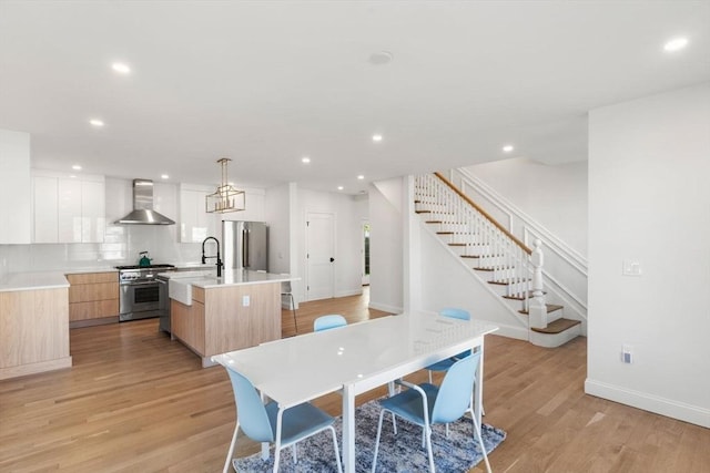 dining space featuring stairs, recessed lighting, baseboards, and light wood-type flooring