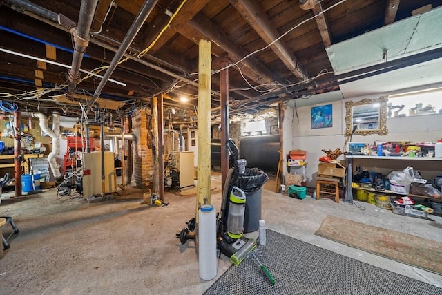 below grade area featuring a heating unit and heating fuel