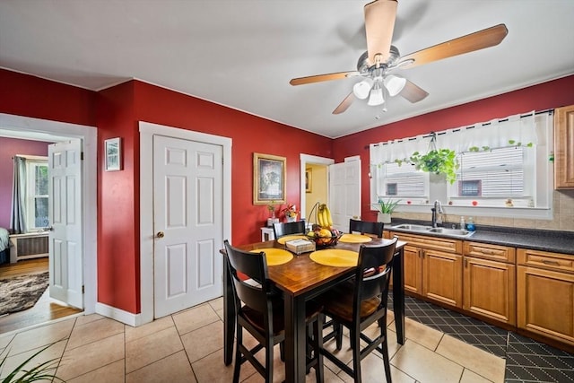 dining room featuring ceiling fan and light tile patterned flooring