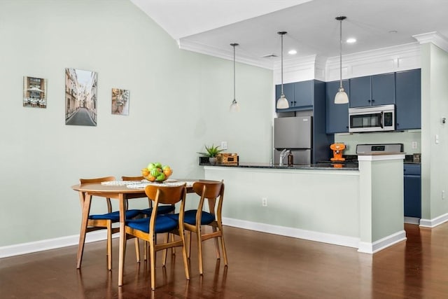 kitchen featuring crown molding, stainless steel appliances, hanging light fixtures, blue cabinets, and a peninsula