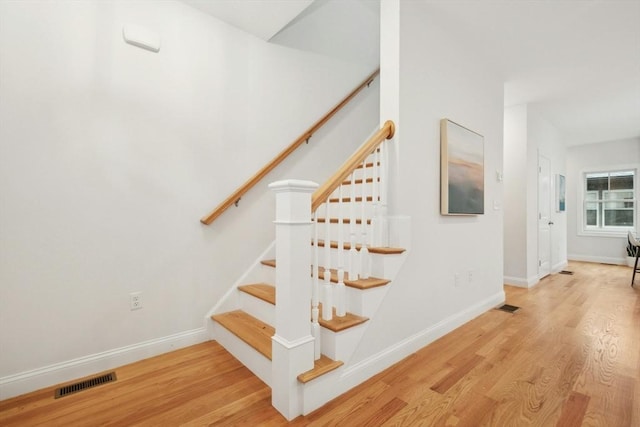 stairs with hardwood / wood-style flooring