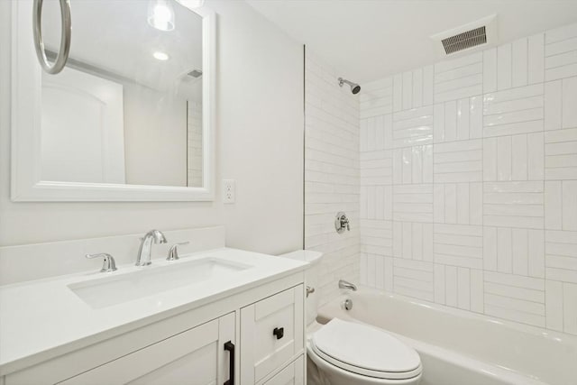 full bathroom with vanity, toilet, and tiled shower / bath combo