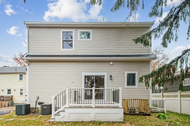 back of house with central AC and a deck