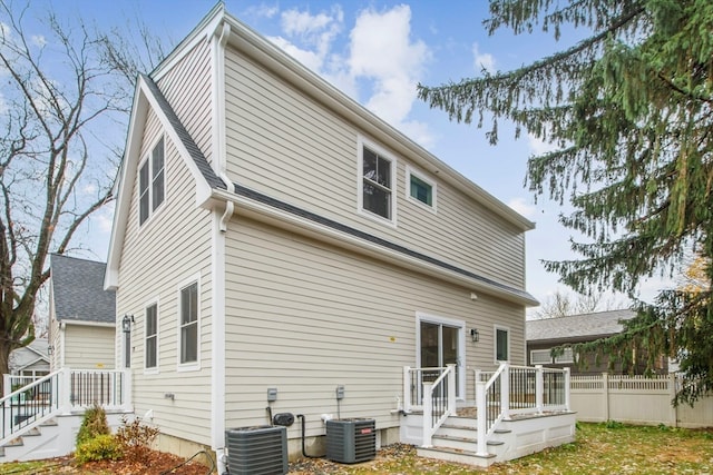 back of house featuring cooling unit and a deck