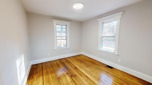 spare room with hardwood / wood-style flooring