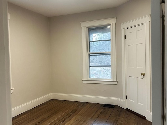 unfurnished room featuring dark hardwood / wood-style flooring