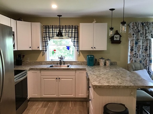 9 Pine City Rd, Carver, MA 02330 - kitchen featuring stainless steel appliances, a sink, a peninsula, and light wood finished floors
