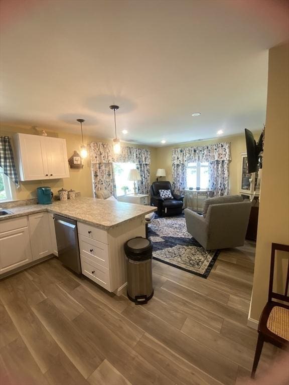 9 Pine City Rd, Carver, MA 02330 - kitchen with dishwasher, a peninsula, white cabinetry, light countertops, and open floor plan