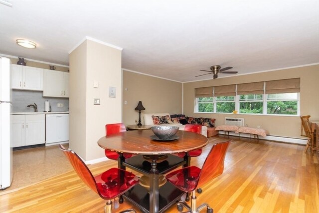 5 Cass St Unit 12, Boston, MA 02132 - dining area featuring a ceiling fan, light wood-style flooring, crown molding, a baseboard heating unit, and baseboards