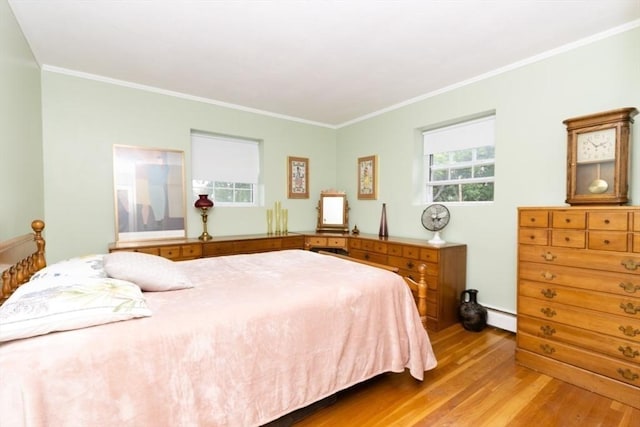 5 Cass St Unit 12, Boston, MA 02132 - bedroom with a baseboard heating unit, wood finished floors, and crown molding