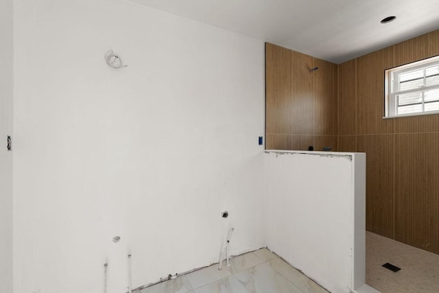 clothes washing area with marble finish floor