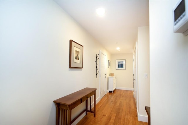 hall with light hardwood / wood-style flooring