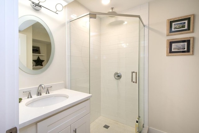 bathroom featuring vanity and a shower with shower door