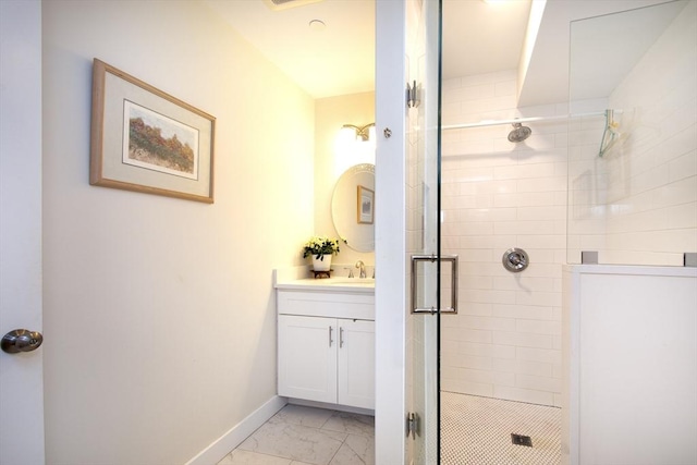 bathroom with vanity and a shower with shower door