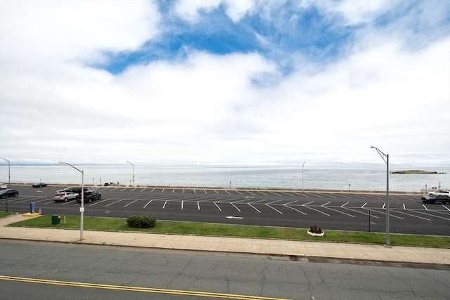 view of parking / parking lot featuring a water view