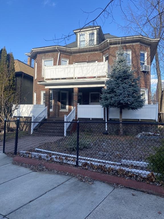 view of front of property with covered porch and a balcony