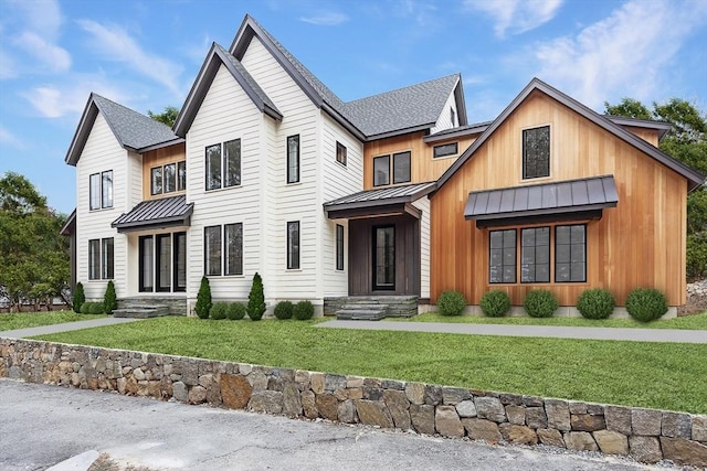 modern farmhouse style home featuring a front lawn