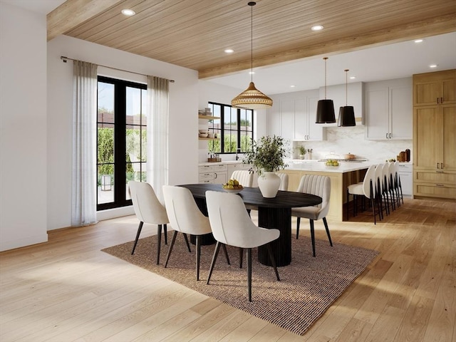 dining room with wood ceiling, beamed ceiling, and light hardwood / wood-style flooring