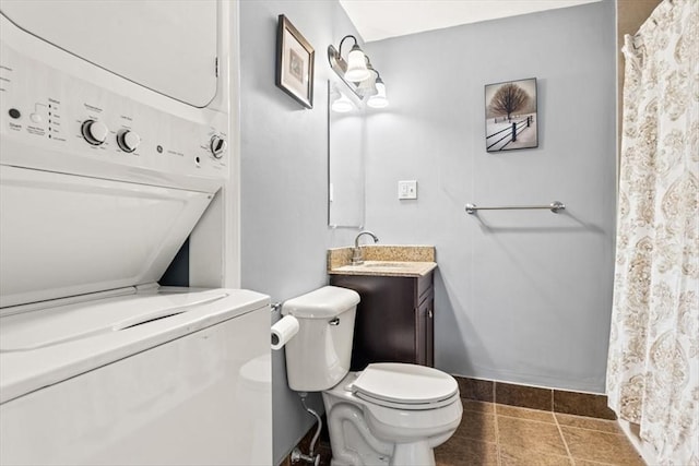 bathroom featuring vanity, stacked washer and clothes dryer, and toilet