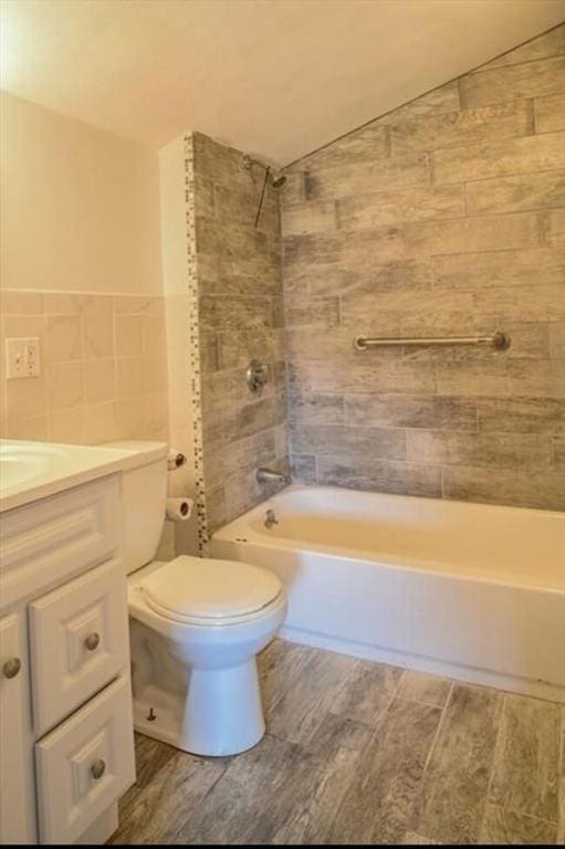 6 Rio, Gloucester, MA 01930 - full bathroom with wood finished floors, bathtub / shower combination, vanity, tile walls, and vaulted ceiling