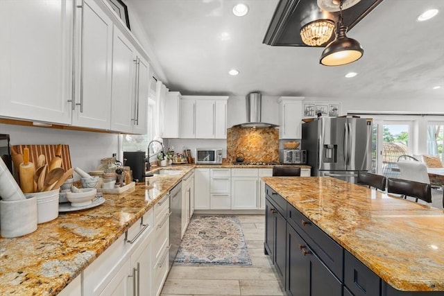 6 Rio, Gloucester, MA 01930 - kitchen featuring appliances with stainless steel finishes, wall chimney range hood, white cabinetry, recessed lighting, and light stone countertops