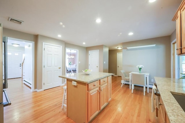 kitchen with a baseboard radiator, recessed lighting, light wood-style flooring, and visible vents