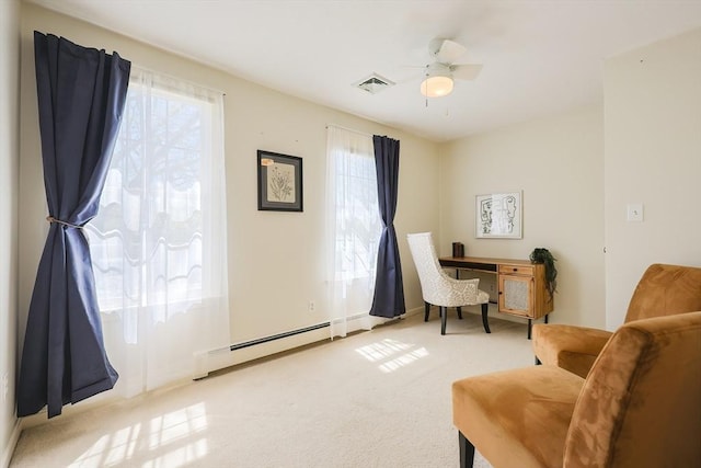 living area with light carpet, a ceiling fan, baseboards, a baseboard radiator, and visible vents