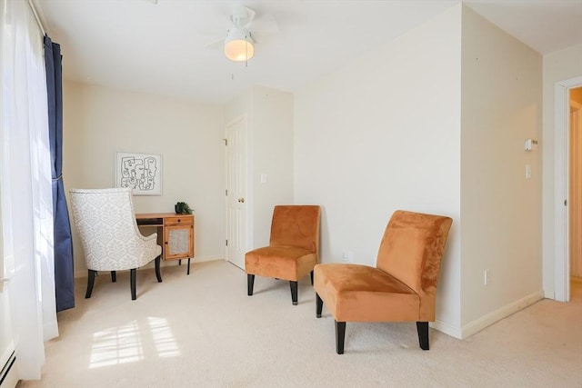 living area with carpet flooring, ceiling fan, baseboards, and a baseboard radiator