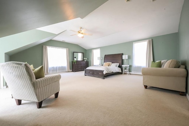 bedroom with carpet, lofted ceiling, and multiple windows