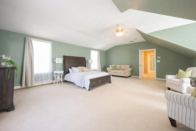 carpeted bedroom featuring a ceiling fan, vaulted ceiling, and multiple windows