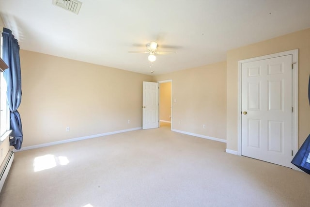 unfurnished bedroom with visible vents, baseboards, ceiling fan, light colored carpet, and a baseboard heating unit
