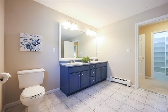full bath with double vanity, a sink, tile patterned floors, a baseboard radiator, and toilet