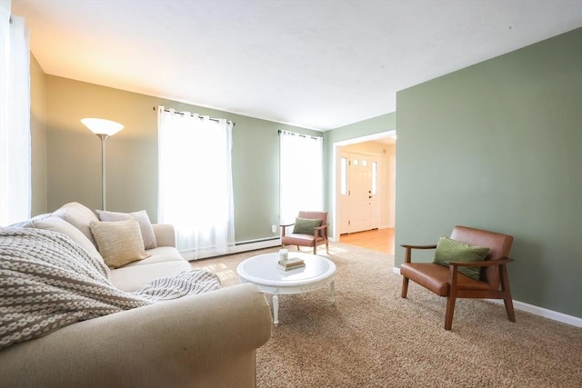 living room featuring baseboards, baseboard heating, and light carpet