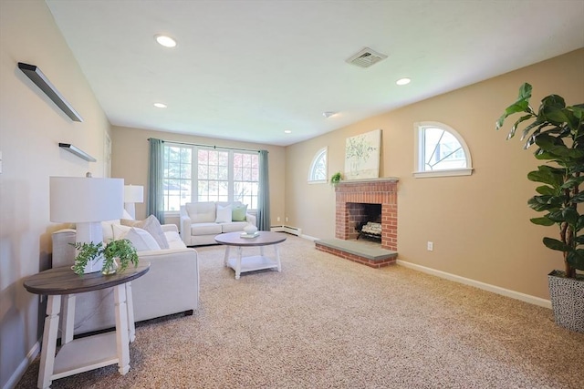 carpeted living area with visible vents, recessed lighting, baseboard heating, and a fireplace