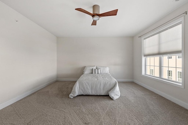 unfurnished bedroom with ceiling fan and carpet floors