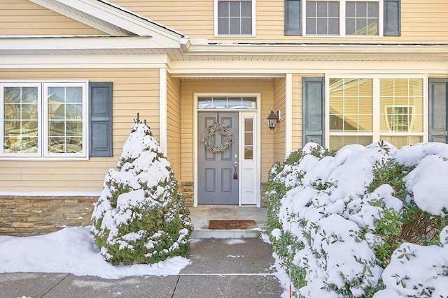 view of snow covered property entrance