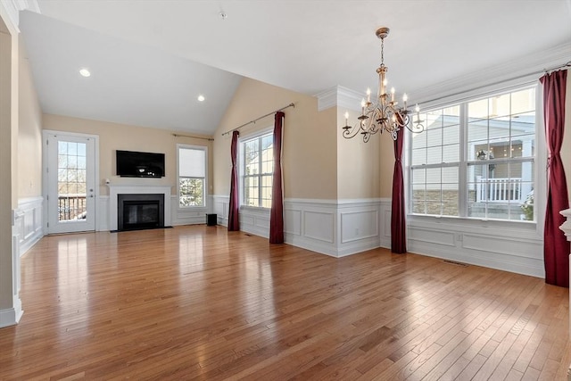 unfurnished dining area featuring light hardwood / wood-style flooring, vaulted ceiling, and a wealth of natural light