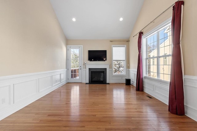 unfurnished living room featuring light hardwood / wood-style flooring and vaulted ceiling