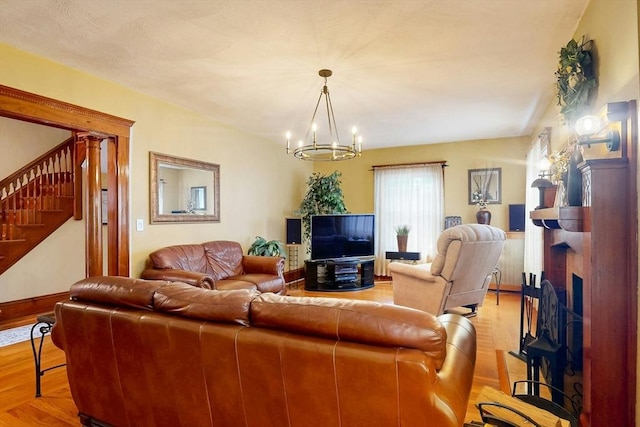 19 Orlando Ave, Winthrop, MA 02152 - living room featuring stairway, a fireplace, a chandelier, baseboards, and light wood-type flooring