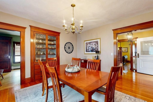 19 Orlando Ave, Winthrop, MA 02152 - dining room with a chandelier, light wood-type flooring, and baseboard heating