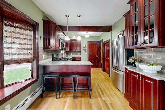 19 Orlando Ave, Winthrop, MA 02152 - kitchen featuring appliances with stainless steel finishes, baseboard heating, dark brown cabinets, and light wood-style flooring