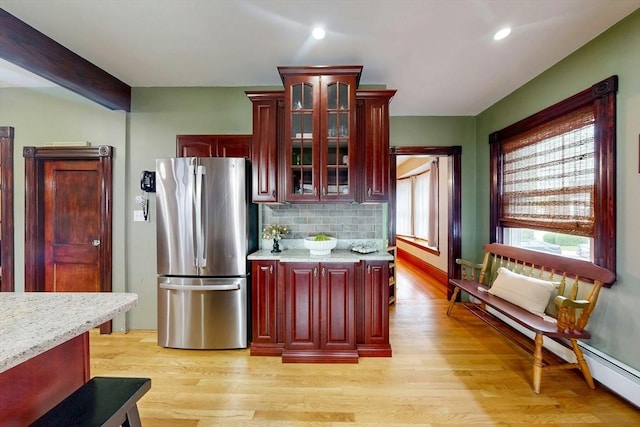 19 Orlando Ave, Winthrop, MA 02152 - kitchen with freestanding refrigerator, dark brown cabinets, light wood finished floors, decorative backsplash, and recessed lighting