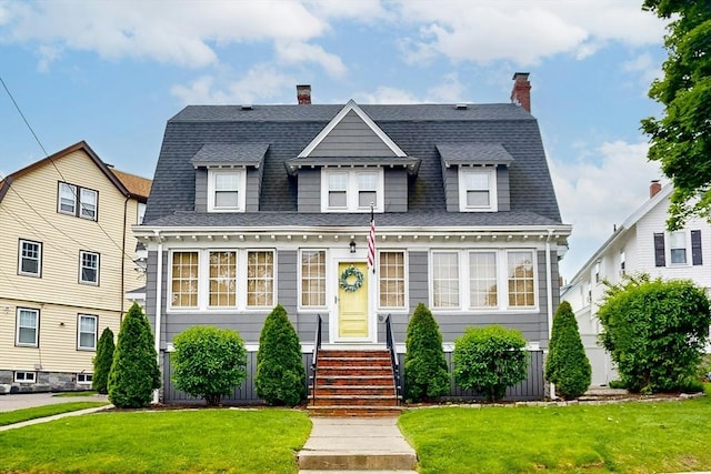19 Orlando Ave, Winthrop, MA 02152 - colonial inspired home featuring a front lawn, a shingled roof, and a chimney